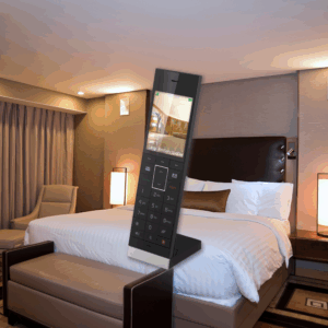 Digitally rendered LCD VTech hotel phone enlarged in the foreground of a modern, well-lit hotel room with a king-sized bed and ambient lighting.